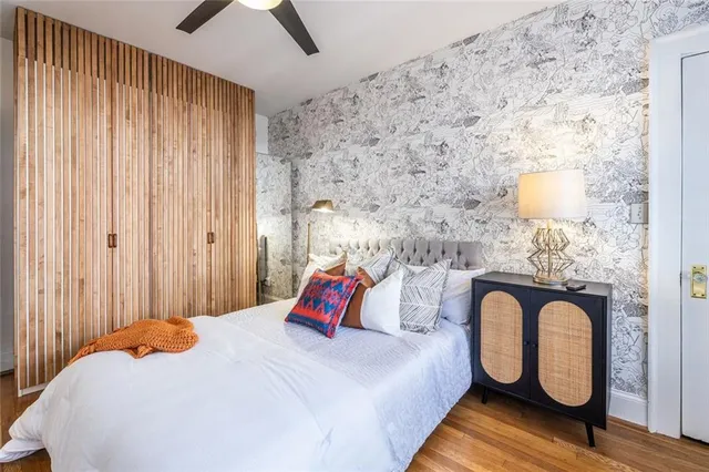 a bedroom with bed and a potted plant