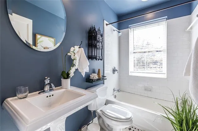 a bathroom with a sink a toilet and a mirror