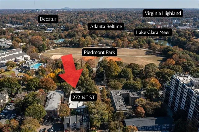 an outdoor space with seating area and trees