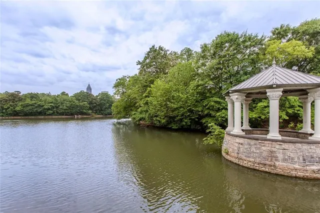 a view of a house with a yard and a pond