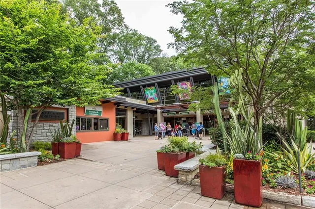 a front view of a house with plants