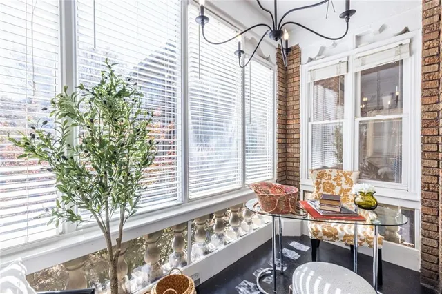 a dining room with furniture and a window