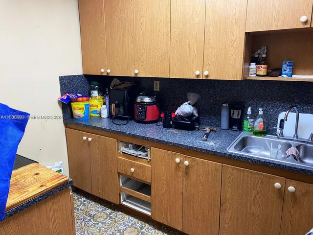 a kitchen with stainless steel appliances granite countertop a sink and a microwave