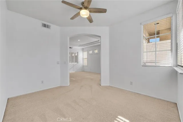a view of a yard in front of a house with plants and large tree