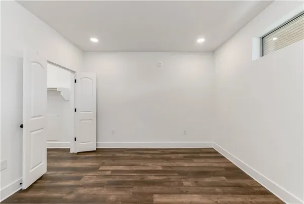 a view of a room with wooden floor
