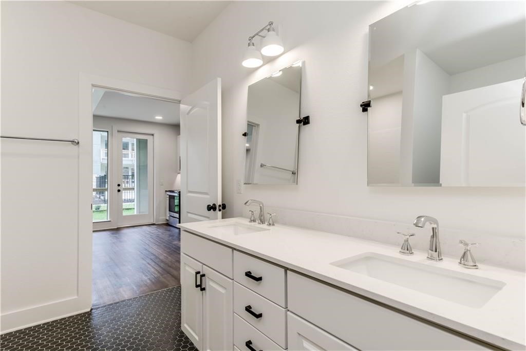 4704 Sunset Trail, Unit 3102 Austin, TX 78745 - Photo 17 of 40 a bathroom with a sink and a mirror