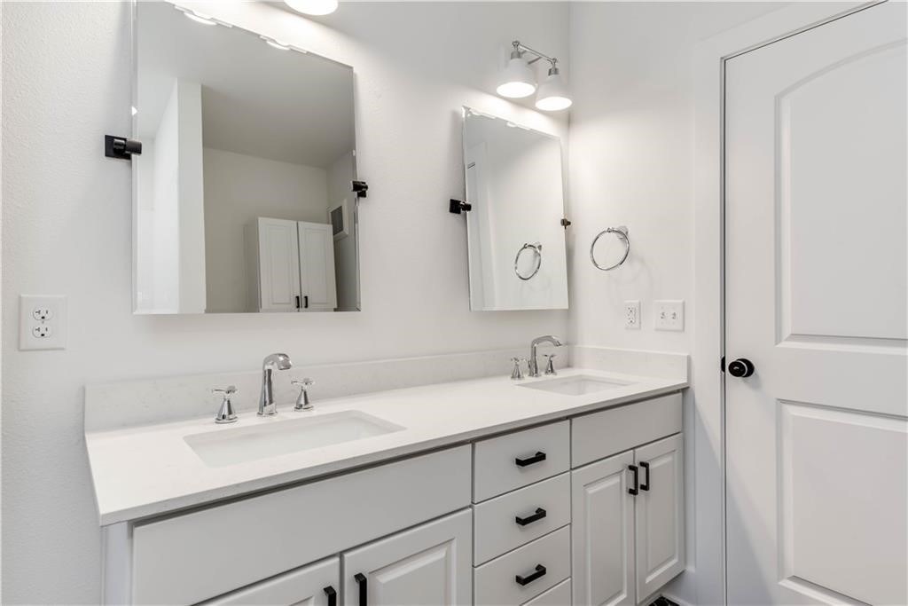 4704 Sunset Trail, Unit 3102 Austin, TX 78745 - Photo 18 of 40 a bathroom with a sink double vanity and a mirror