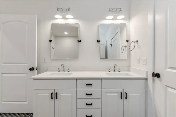 a bathroom with a double vanity sink mirror and