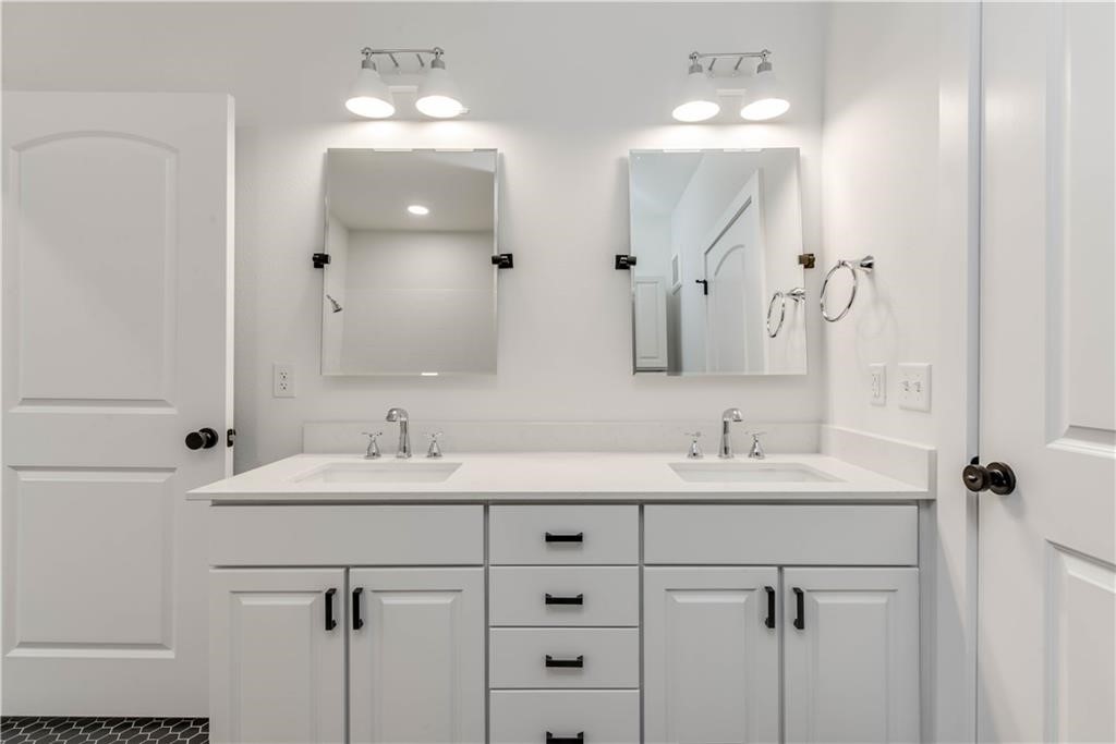 4704 Sunset Trail, Unit 3102 Austin, TX 78745 - Photo 20 of 40 a bathroom with a double vanity sink mirror and