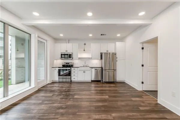 a kitchen with refrigerator and microwave