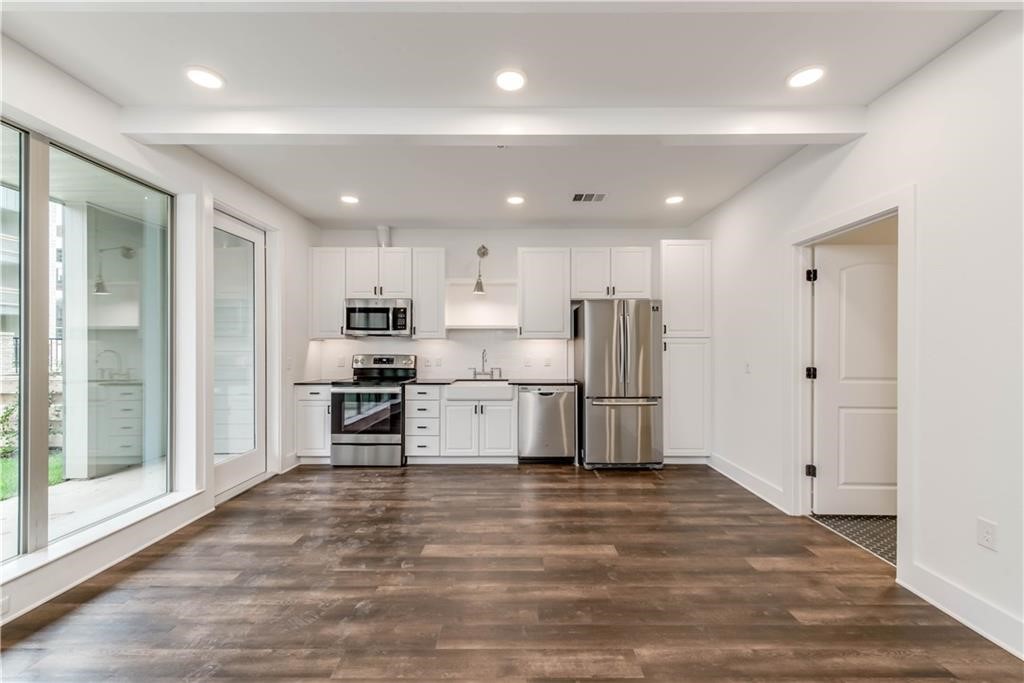 4704 Sunset Trail, Unit 3102 Austin, TX 78745 - Photo 2 of 40 a kitchen with refrigerator and microwave