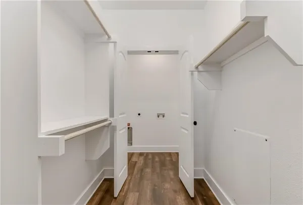 a view of walk in closet with empty racks