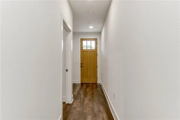 a view of a hallway with wooden floor