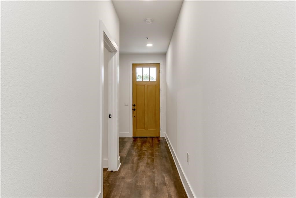 4704 Sunset Trail, Unit 3102 Austin, TX 78745 - Photo 23 of 40 a view of a hallway with wooden floor