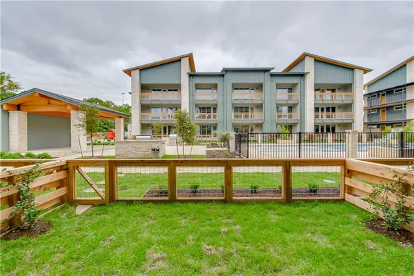 a view of a house with a yard and sitting area