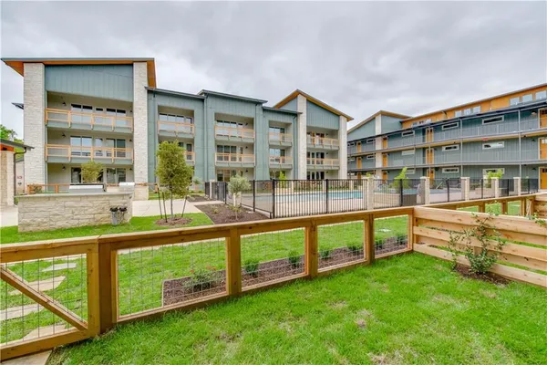 a view of an apartment with a swimming pool