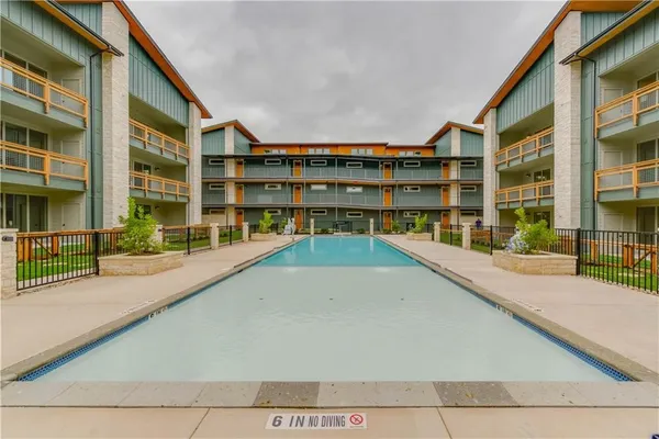 a view of swimming pool with building exterior