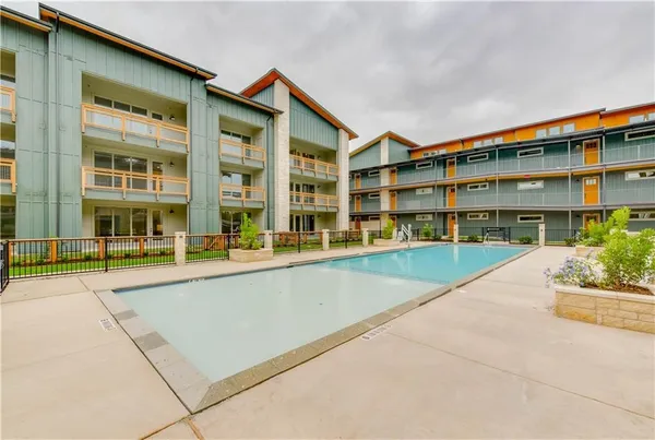 a view of building with a swimming pool