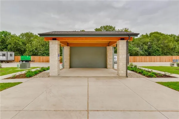 a front view of a house with a yard and a garage