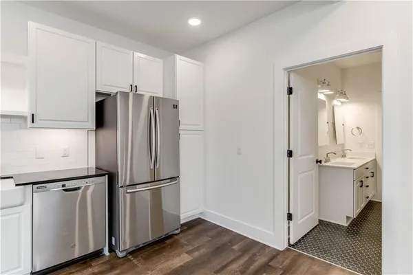 a kitchen with stainless steel appliances a refrigerator and cabinets