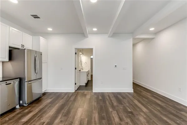 a view of empty room with wooden floor