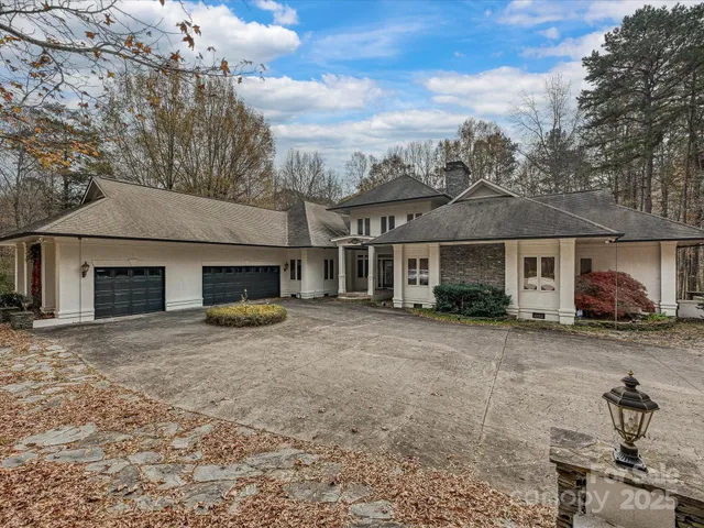 a front view of a house with yard and parking