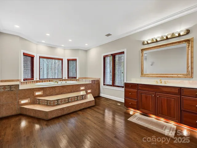 a spacious bedroom with a bed and a dresser