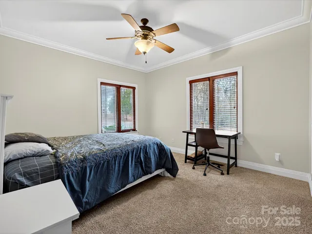 a utility room with fridge and wooden floor