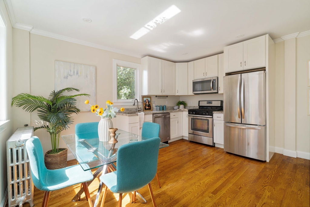 16 Partridge Avenue Somerville, MA 02145 - Photo 11 of 32 a kitchen with white cabinets and stainless steel appliances