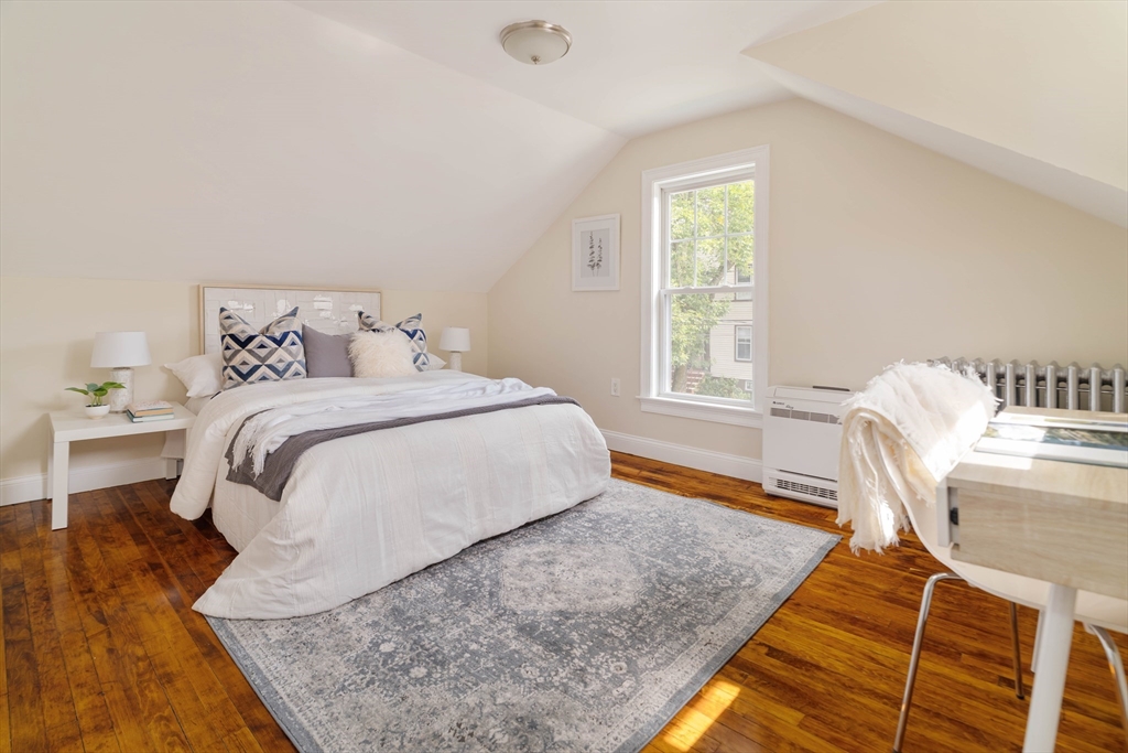 16 Partridge Avenue Somerville, MA 02145 - Photo 17 of 32 a bedroom with a bed and wooden floor