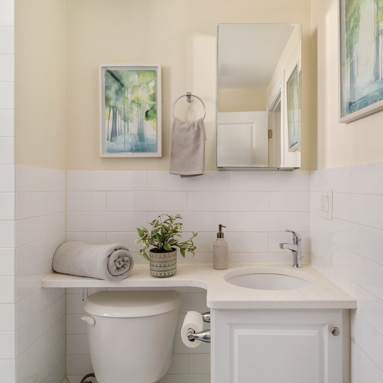 16 Partridge Avenue Somerville, MA 02145 - Photo 21 of 32 a bathroom with a toilet a sink and mirror