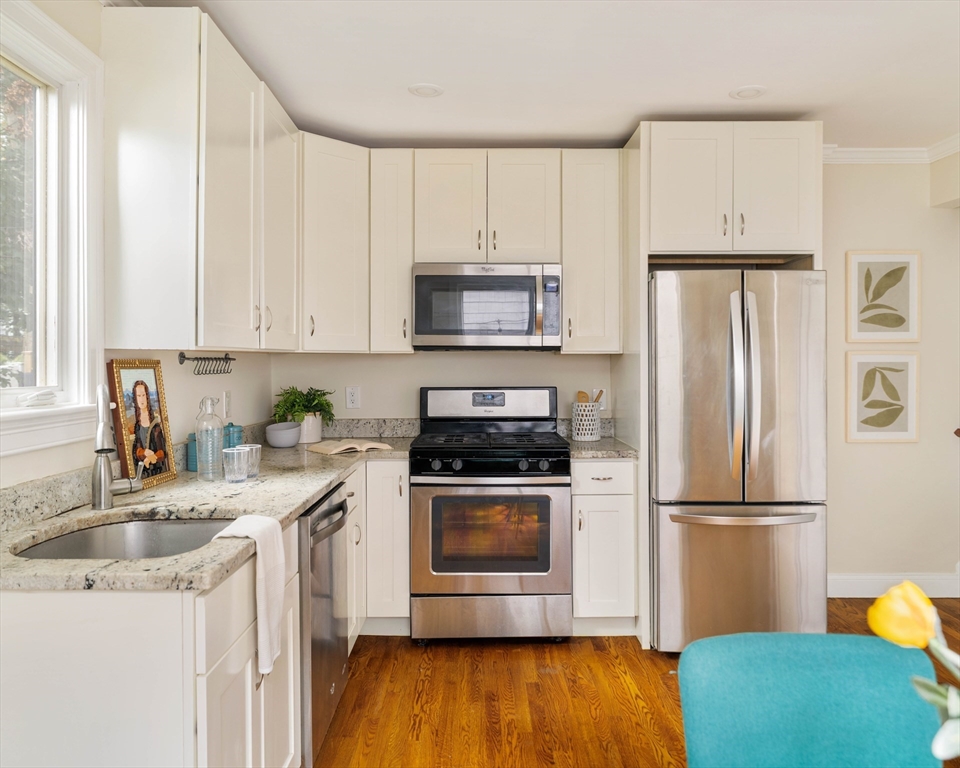 16 Partridge Avenue Somerville, MA 02145 - Photo 8 of 32 a kitchen with a sink a refrigerator and a stove top oven