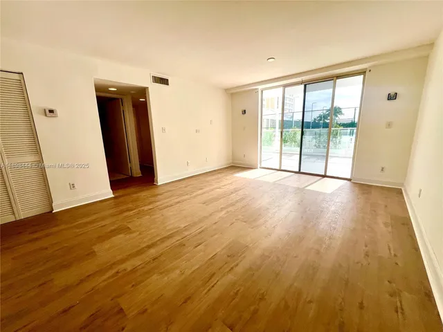 a kitchen with stainless steel appliances granite countertop a refrigerator a stove top oven a sink and dishwasher