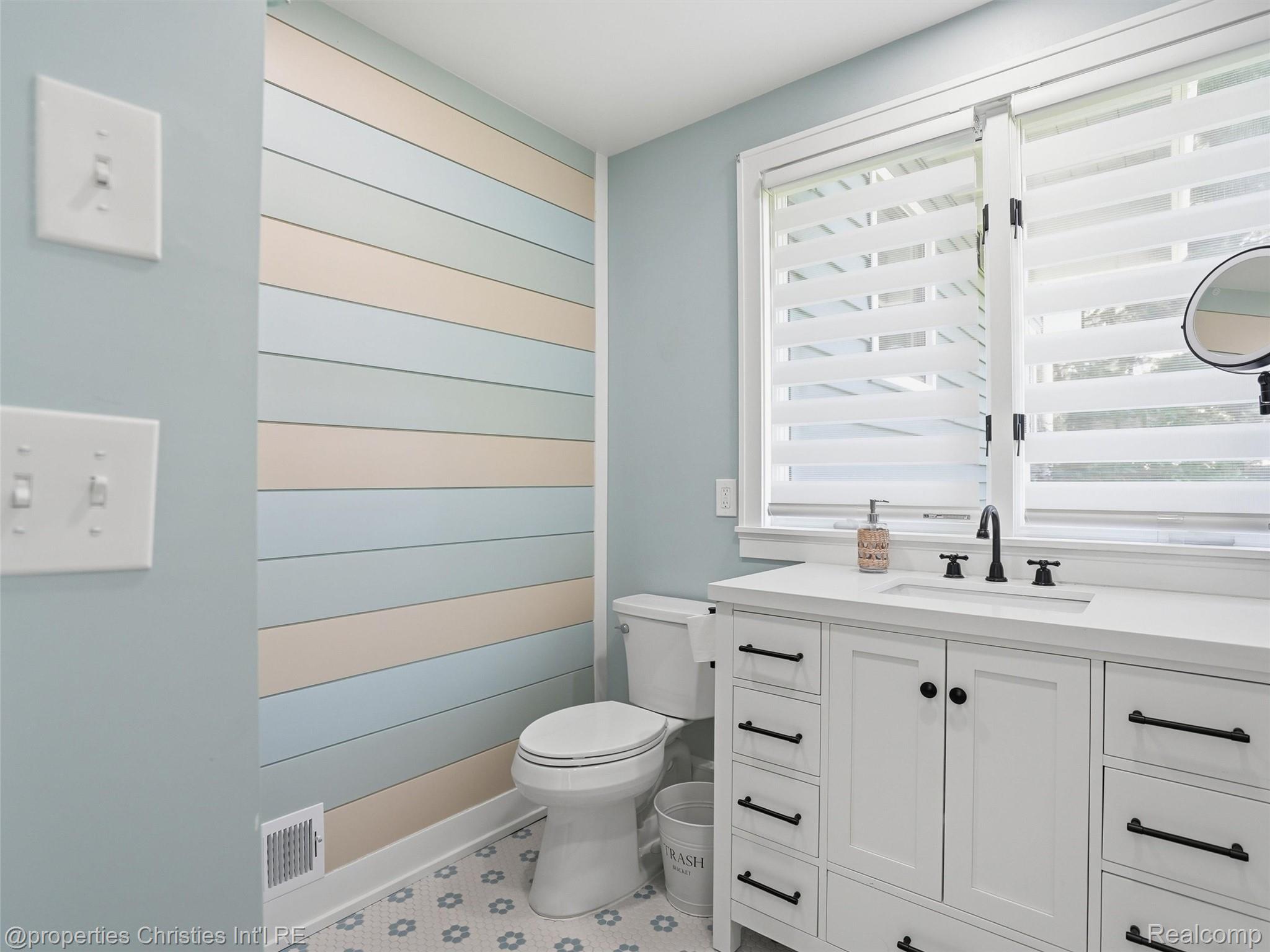 8645 Toma Road Pinckney, MI 48169 - Photo 21 of 65 Newly renovated primary bath, ceramic tile flooring and custom shiplap wall treatment