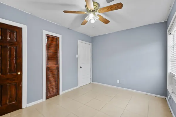 a view of a livingroom with a ceiling fan and window
