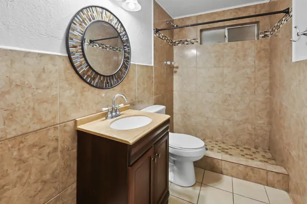 a bathroom with a sink a toilet and a mirror