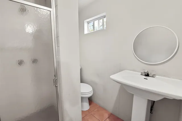 a view of a backyard with table and chairs under an umbrella