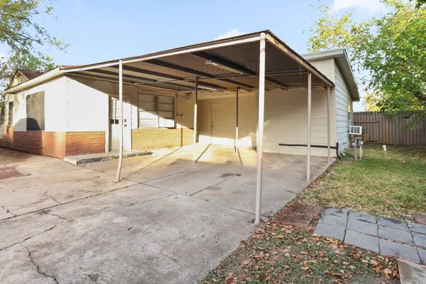 a backyard of a house with table and chairs