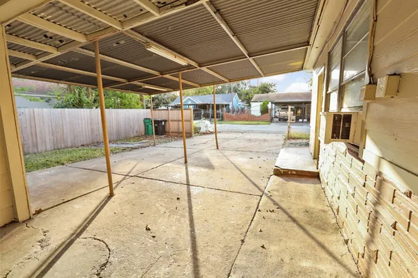 a view of a backyard with table and chairs under an umbrella