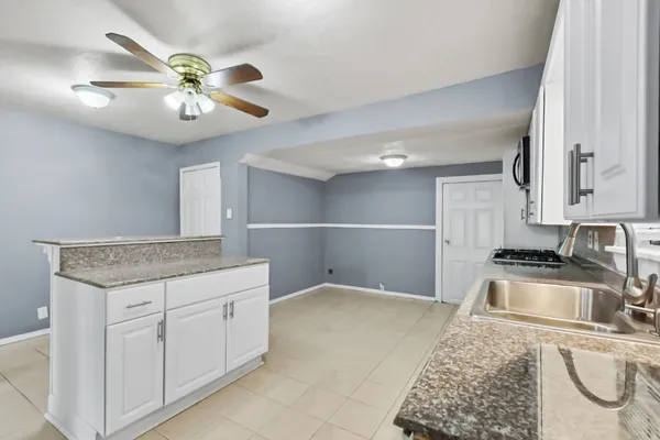 a kitchen with stainless steel appliances granite countertop a sink dishwasher stove and refrigerator