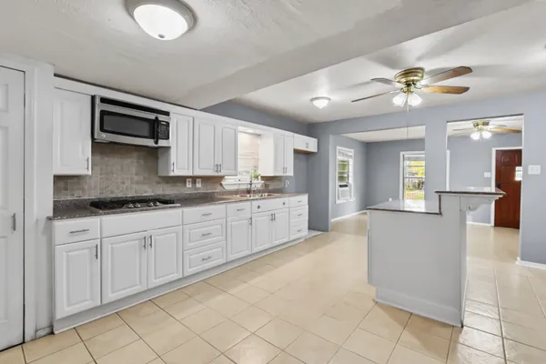 a kitchen with cabinets and window