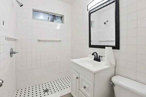 a bathroom with a sink toilet and shower