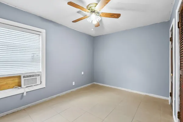 a view of a livingroom with a ceiling fan and window