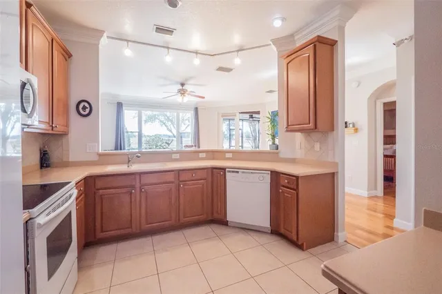 a kitchen with stainless steel appliances granite countertop a refrigerator sink and stove
