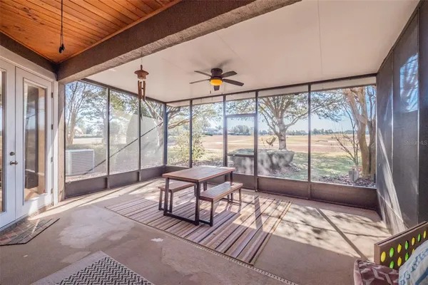 a living room with a balcony furniture and a large window