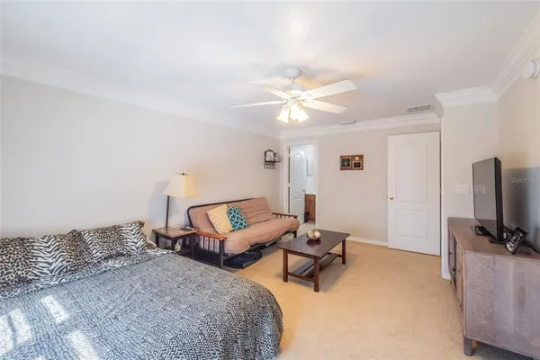 a bedroom with a bed and a chandelier