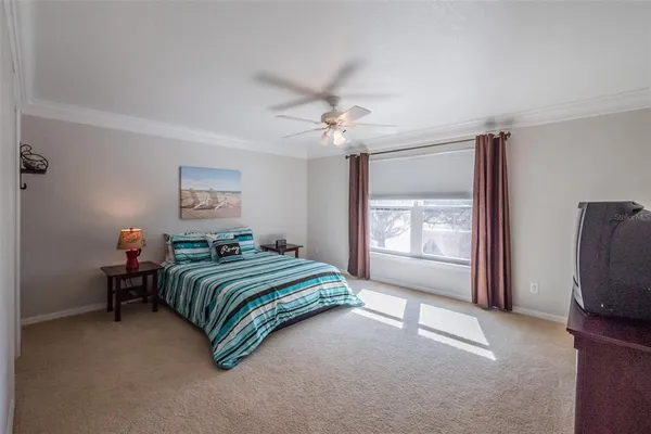 an aerial view of a house with a yard and lake view