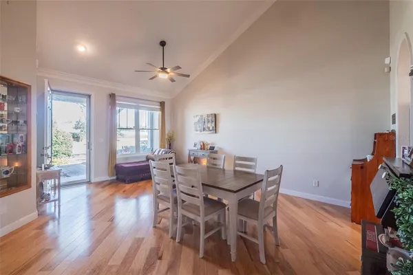 a dining room with furniture a chandelier and wooden floor