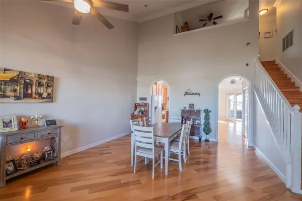 a dining room with furniture entryway and wooden floor
