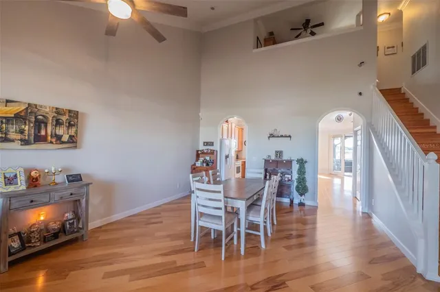 a dining room with furniture entryway and wooden floor